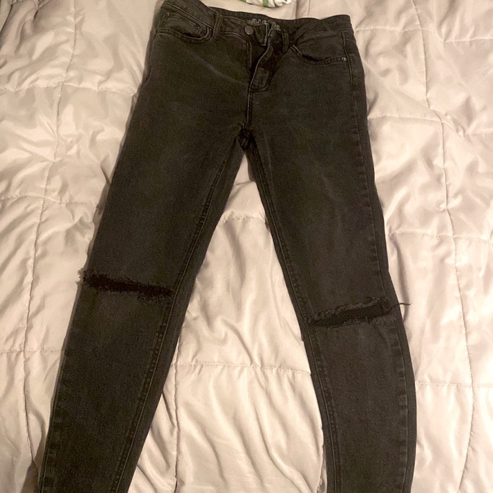 Black wash jeans with distress in the knees